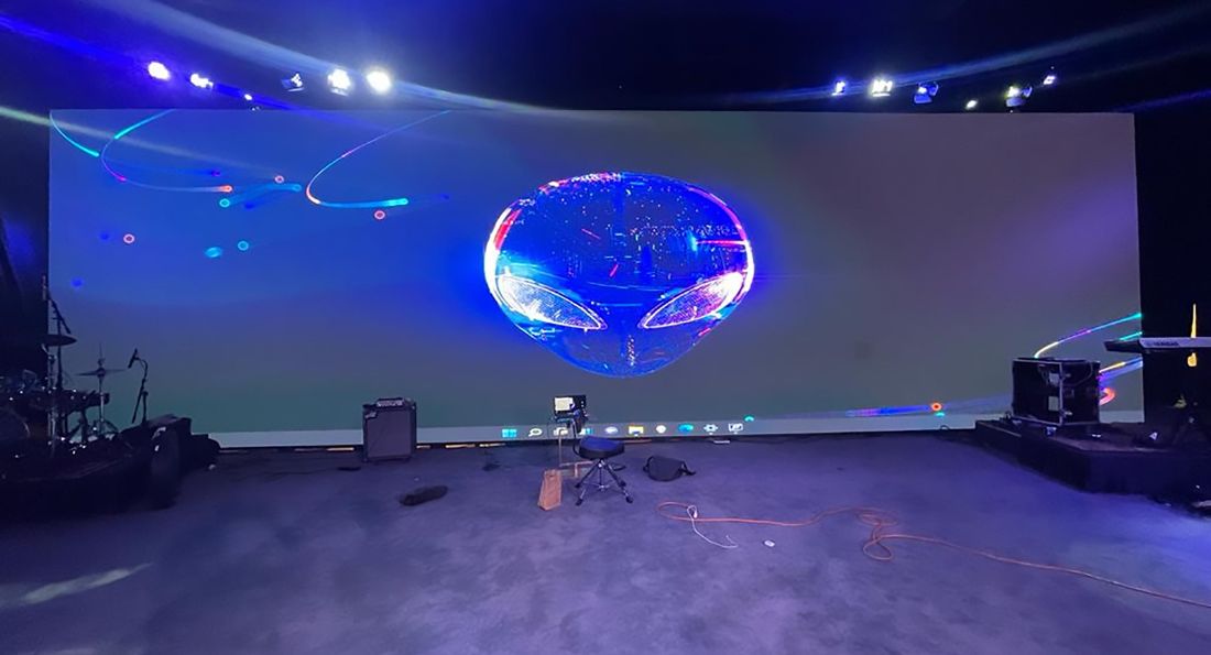 Spherical LED display glowing in a dark event space