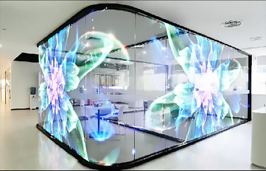 Transparent LED wall in an office showing a bright full-colour image while the room stays visible through it